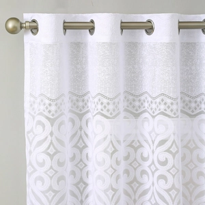 White lace grommet curtain featuring vintage floral patterns on golden metal rod