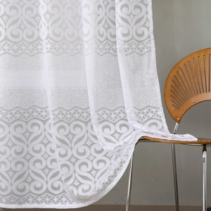 White lace curtain with elegant floral jacquard pattern draped on a wooden chair