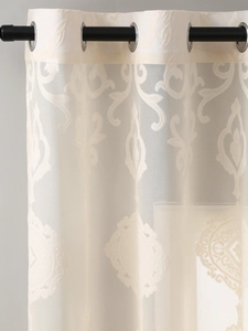 Close-up of beige sheer curtain fabric featuring vintage damascus jacquard floral patterns