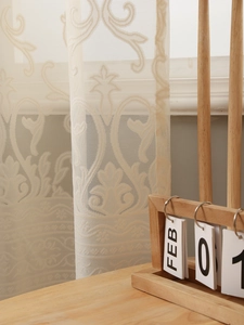 Close-up of beige lace curtain featuring intricate damascus floral jacquard pattern