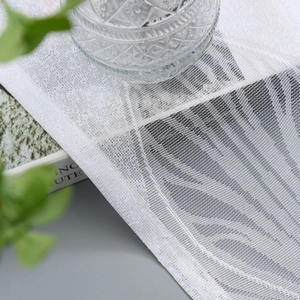 White feather mesh curtain with grommets showing fine grid texture and elegant drape