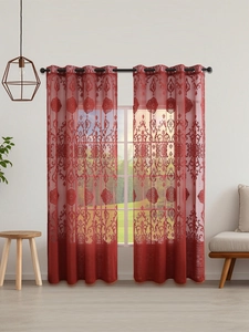 Close-up of red damascus embroidery on semi-sheer curtains with black metal grommets