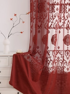 Detailed close-up of dark red lace embroidery curtain with elegant baroque floral patterns