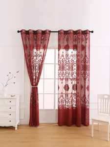 Detail of red embroidered sheer curtains with elegant floral patterns and metal eyelets