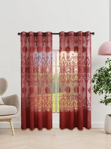 Detail of red damascus embroidery on sheer curtains with metal grommet rings