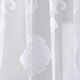 Detail of white semi-transparent lace curtain with intricate floral jacquard pattern