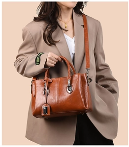 Detail of vintage oil wax leather tote with braided handle and adjustable shoulder strap