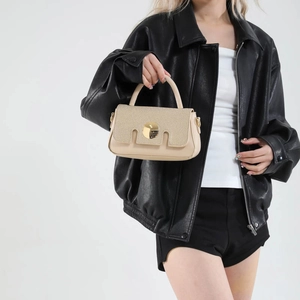 French chic cream crossbody bag with leather and canvas patchwork and gold buckle