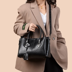 Vintage black oil wax leather tote bag with top handle and crossbody strap for women