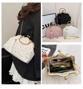 Detail view of pearl embroidery handbag showing interior capacity for phone and cosmetics