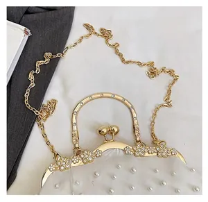 Detail of vintage white shell bag featuring pearl beadwork and floral rhinestone clasp