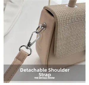 Detail view of the beige PU leather bag showing silver metal hooks and detachable strap