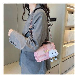 Detail of pink leather and woven crossbody bag with golden H buckle and cloud charm
