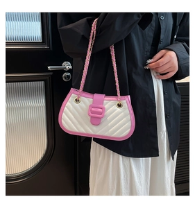 Close-up of quilted pattern and pink buckle detail on stylish chain crossbody bag