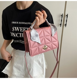 Detailed shot of pink quilted leather bag with silk scarf handle and gold turn-lock
