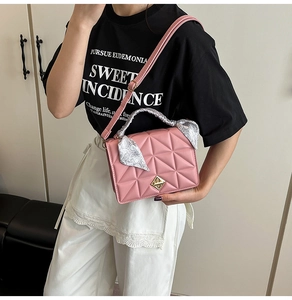 Pink quilted shoulder bag with gold twist lock and floral silk scarf on handle