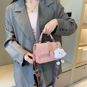 Pink woven patchwork crossbody bag with patterned wide strap and plush cloud charm