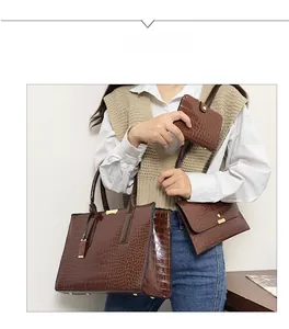 Three-piece set of brown faux crocodile leather tote bag, crossbody bag, and wallet with gold hardware
