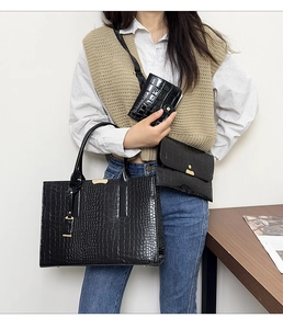 Detailed set of black crocodile embossed tote bag with gold hardware and matching pouches