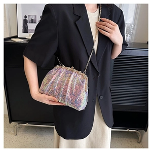 Detail of iridescent sequin shell bag with pearl rhinestone clasp and metal chain