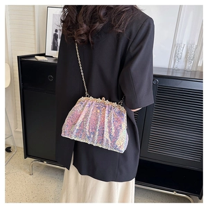 Close-up of sequined shell bag with iridescent purple sequins and pearl clasp details