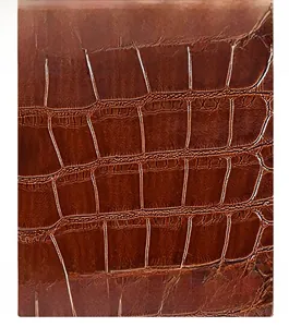 Close-up of brown tote bag showing detailed faux crocodile leather texture and finish
