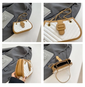Detail of quilted leather crossbody bag with chain strap and contrast trim details