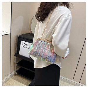 Detail of iridescent sequin shell bag with gold chain strap on a crossbody model