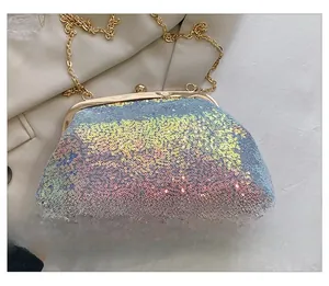 Detail view of colorful iridescent sequins on shell bag back with golden metal frame