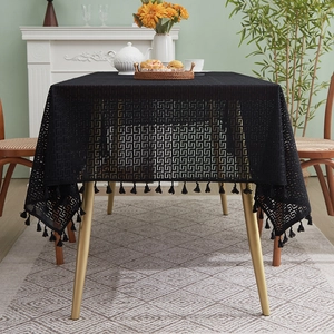 Elegant black lace tablecloth with fringe trim on dining table with tea set decor