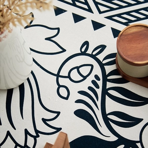 Detailed close-up of bohemian geometric patterns on linen blend textured tablecloth