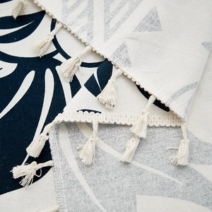 Linen table cloth with blue leaf print and woven tassels in bohemian style