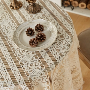 Detailed shot of bohemian hollow out lace tablecloth with cream vintage floral patterns