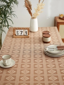 Detailed view of hollow lace patterns on beige cotton linen fabric tablecloth