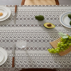 Bohemian white lace tablecloth with geometric patterns on a wooden dining table