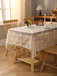 Detail of bohemian lace tablecloth featuring hollowed bird patterns and tassel fringe
