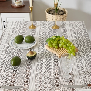 Detail of bohemian lace tablecloth with geometric hollow patterns on a set dining table