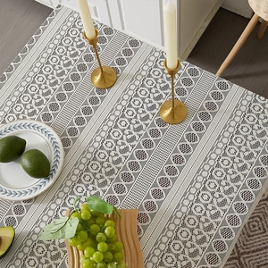 Close-up of white bohemian lace tablecloth featuring intricate hollow woven patterns