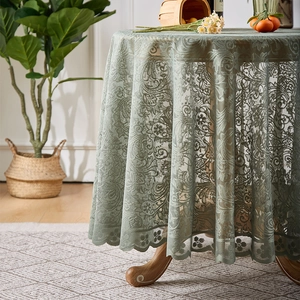 Pale green lace tablecloth with floral hollow patterns and elegant scalloped edges