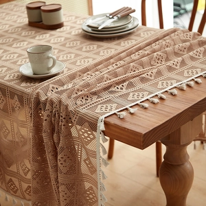 Beige hollow crochet tablecloth with geometric diamond patterns and tassel edges