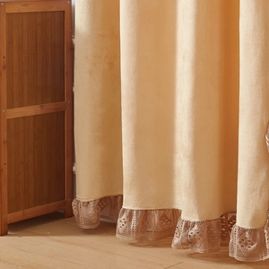 Detail of velvet thermal curtain showing beige fabric and hollow geometric lace trim