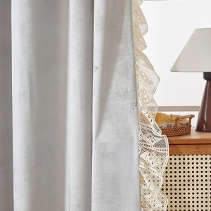Close-up of chenille blackout curtain with delicate white lace edges in French retro style