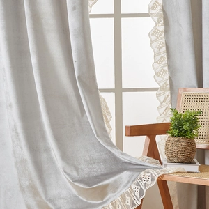 Detail of light gray velvet curtain with off-white lace trim and soft plush texture