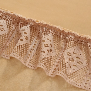 Detailed close-up of khaki velvet curtain fabric with elegant lace trim and ruffles