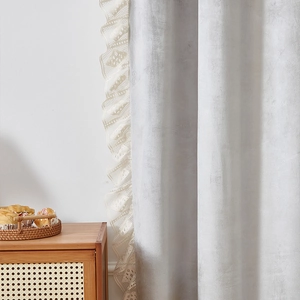 Detail of light gray chenille curtain with cream white lace ruffle and velvet texture