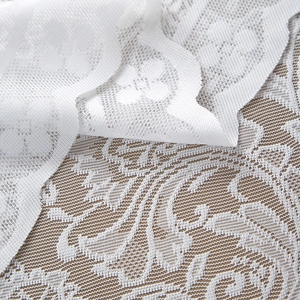 Detailed close-up of French lace tablecloth featuring delicate floral embroidery and mesh