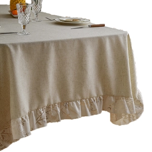 Beige linen rectangular tablecloth with ruffle edges and delicate leaf pattern