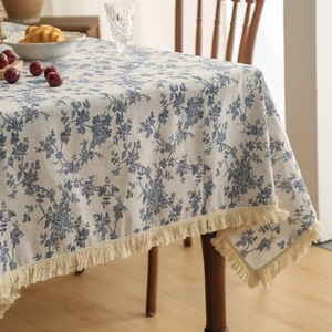 Linen cotton tablecloth with blue floral pattern and decorative tassel fringe edges