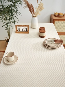 Detailed herringbone texture on cream linen-blend rectangular tablecloth for home decor