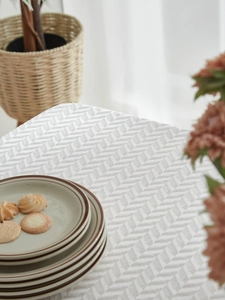 Detail of light grey zigzag woven tablecloth with a textured fabric finish